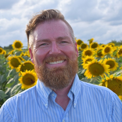 Brian Kabell headshot in sunflowers.jpg