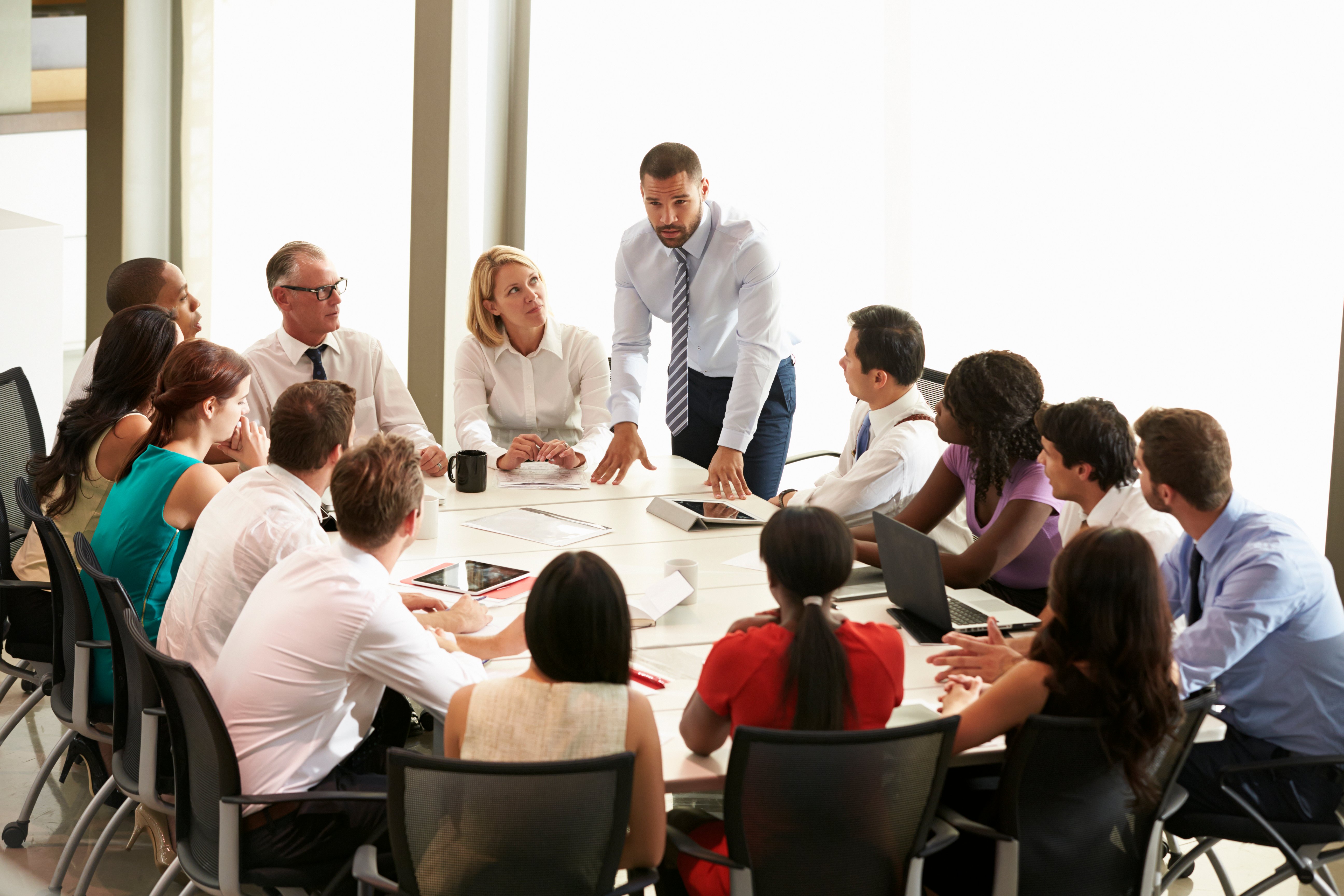 businessman-addressing-meeting-around-boardroom-crc-site